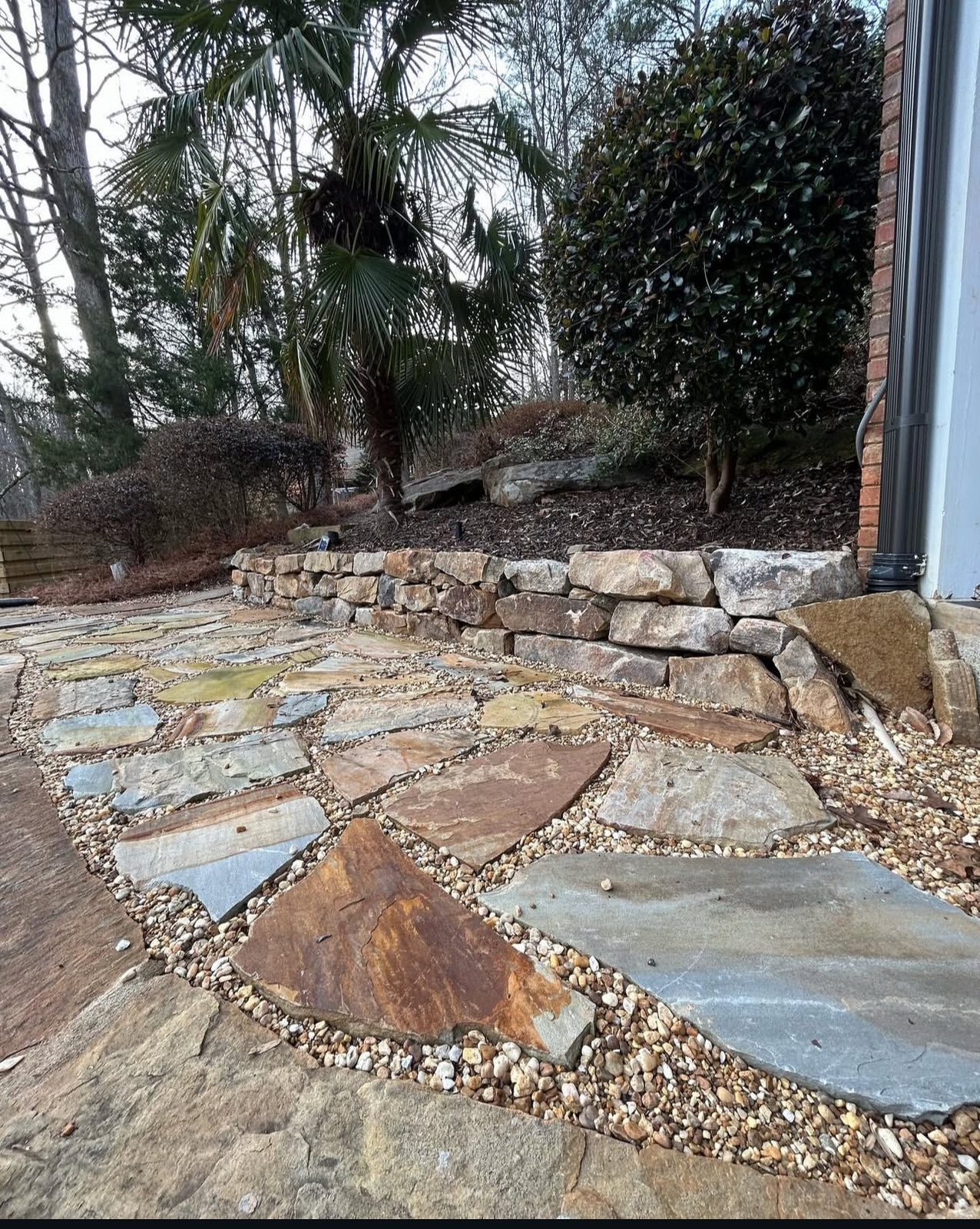 Flagstone patio with stacked stone wall