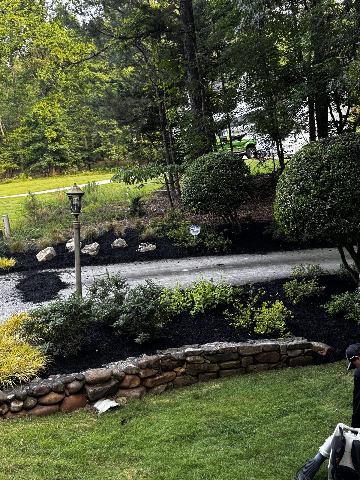 Mulch installation with stone wall, residential